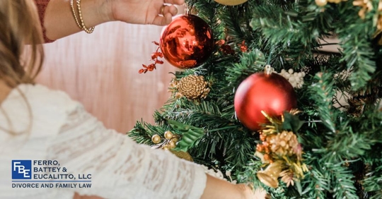 child decorating a tree