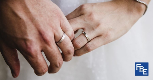 two hands wearing wedding rings